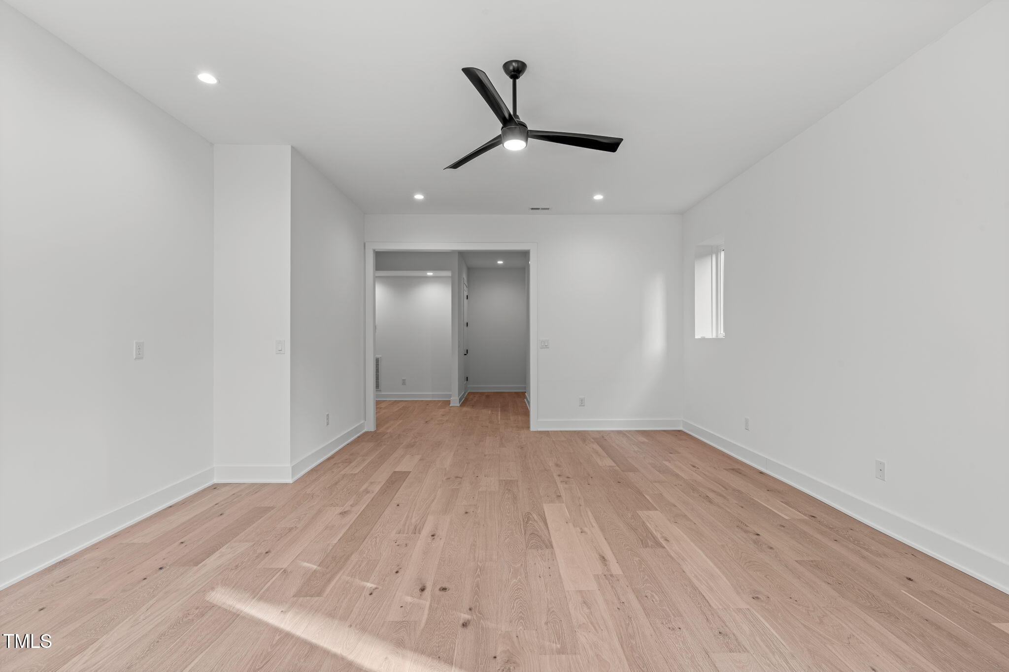 1439 Duplin Road Raleigh, NC 27607 - Photo 57 of 78 an empty room with wooden floor ceiling fan and windows