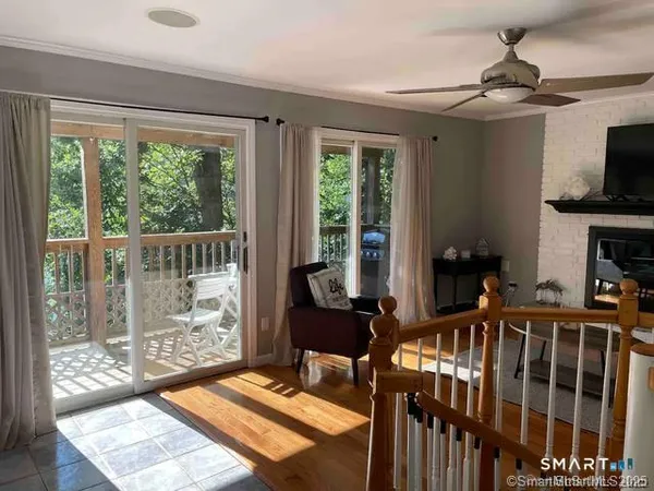 a living room with furniture tv and a window
