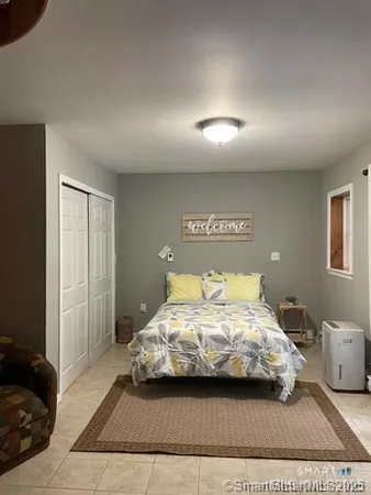 a bedroom with a bed and a night stand