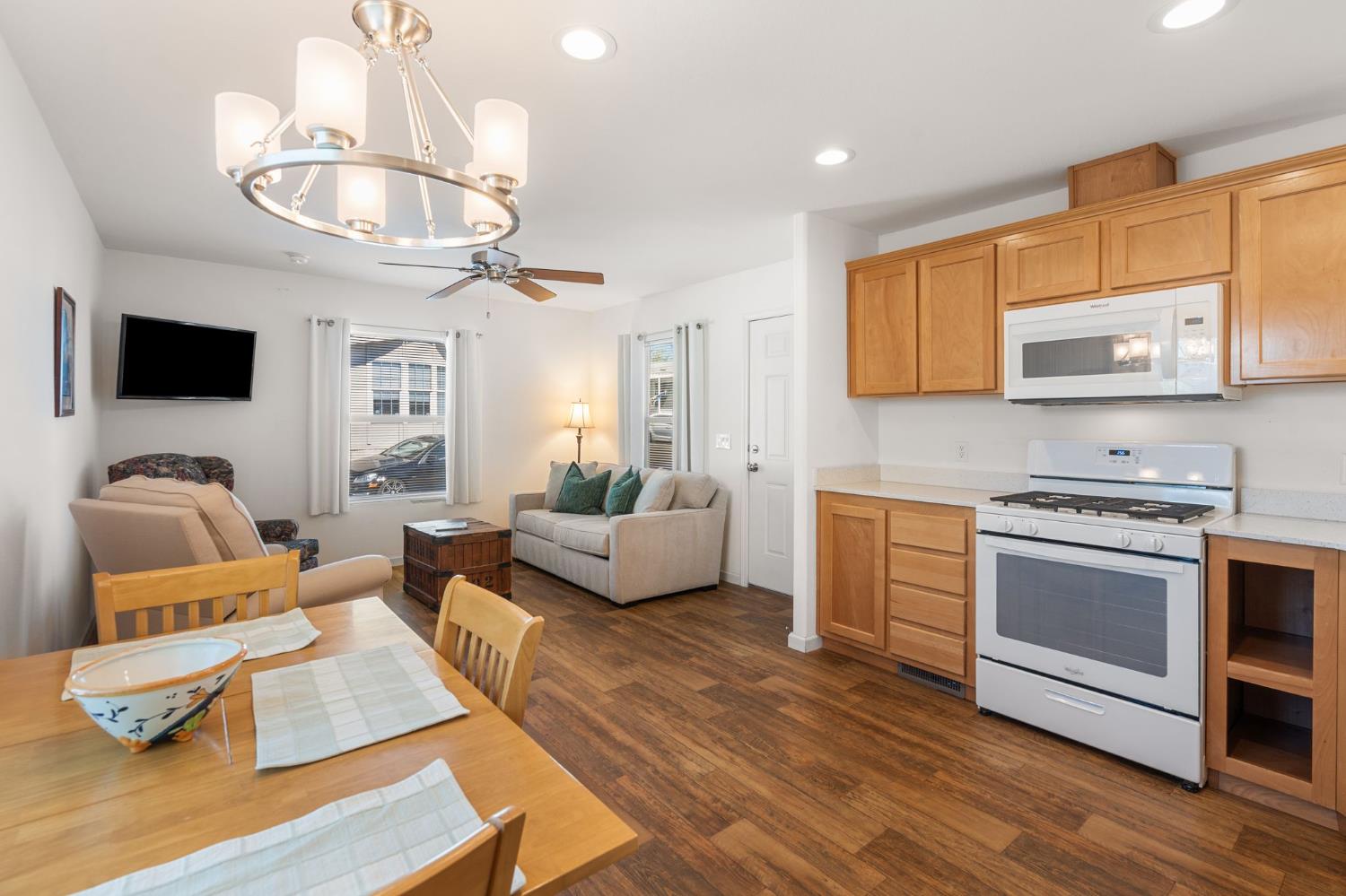 4695 Pacific Street, Unit 9 Rocklin, CA 95667 - Photo 1 of 27 a living room with furniture a flat screen tv and kitchen view