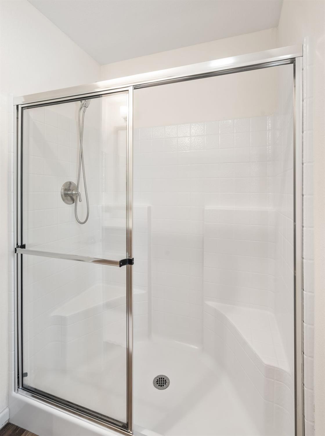 4695 Pacific Street, Unit 9 Rocklin, CA 95667 - Photo 13 of 27 a bathroom with a glass shower door