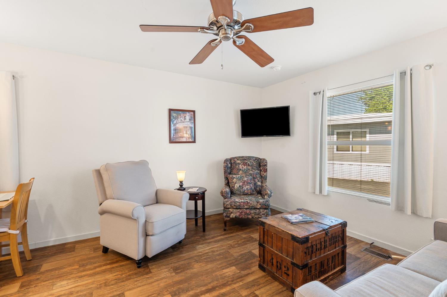 4695 Pacific Street, Unit 9 Rocklin, CA 95667 - Photo 3 of 27 a living room with furniture a flat screen tv and a window
