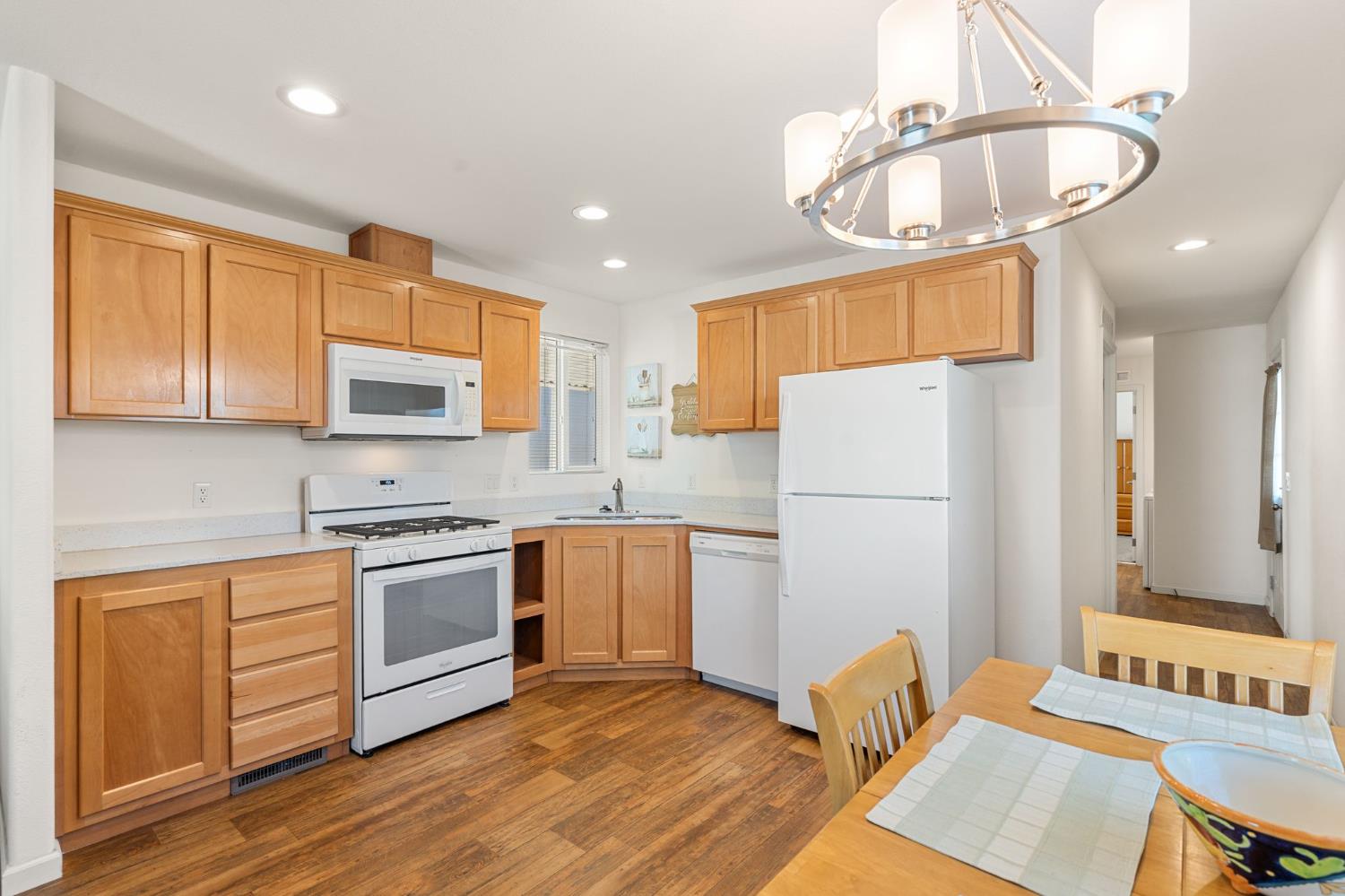 4695 Pacific Street, Unit 9 Rocklin, CA 95667 - Photo 6 of 27 a kitchen with stainless steel appliances granite countertop a refrigerator a stove top oven a sink dishwasher and white cabinets