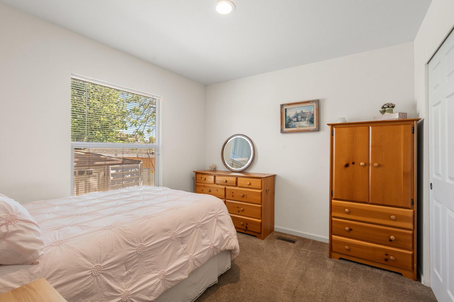 4695 Pacific Street, Unit 9 Rocklin, CA 95667 - Photo 9 of 27 a bedroom with a bed and a dresser