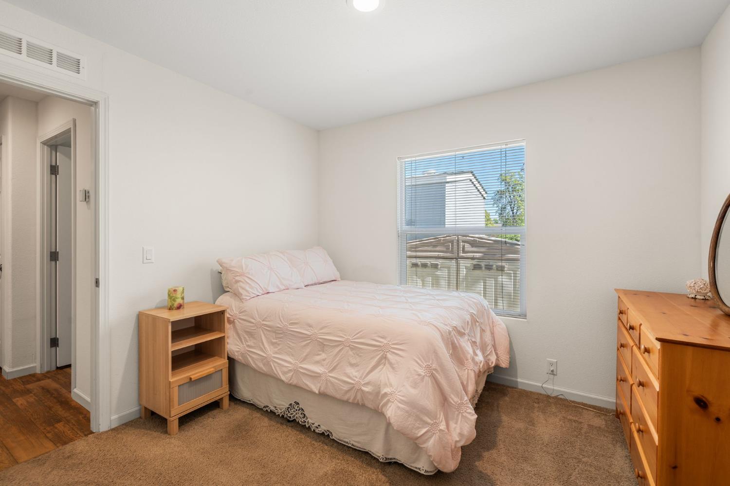4695 Pacific Street, Unit 9 Rocklin, CA 95667 - Photo 10 of 27 a bedroom with a bed and a tv on the dresser