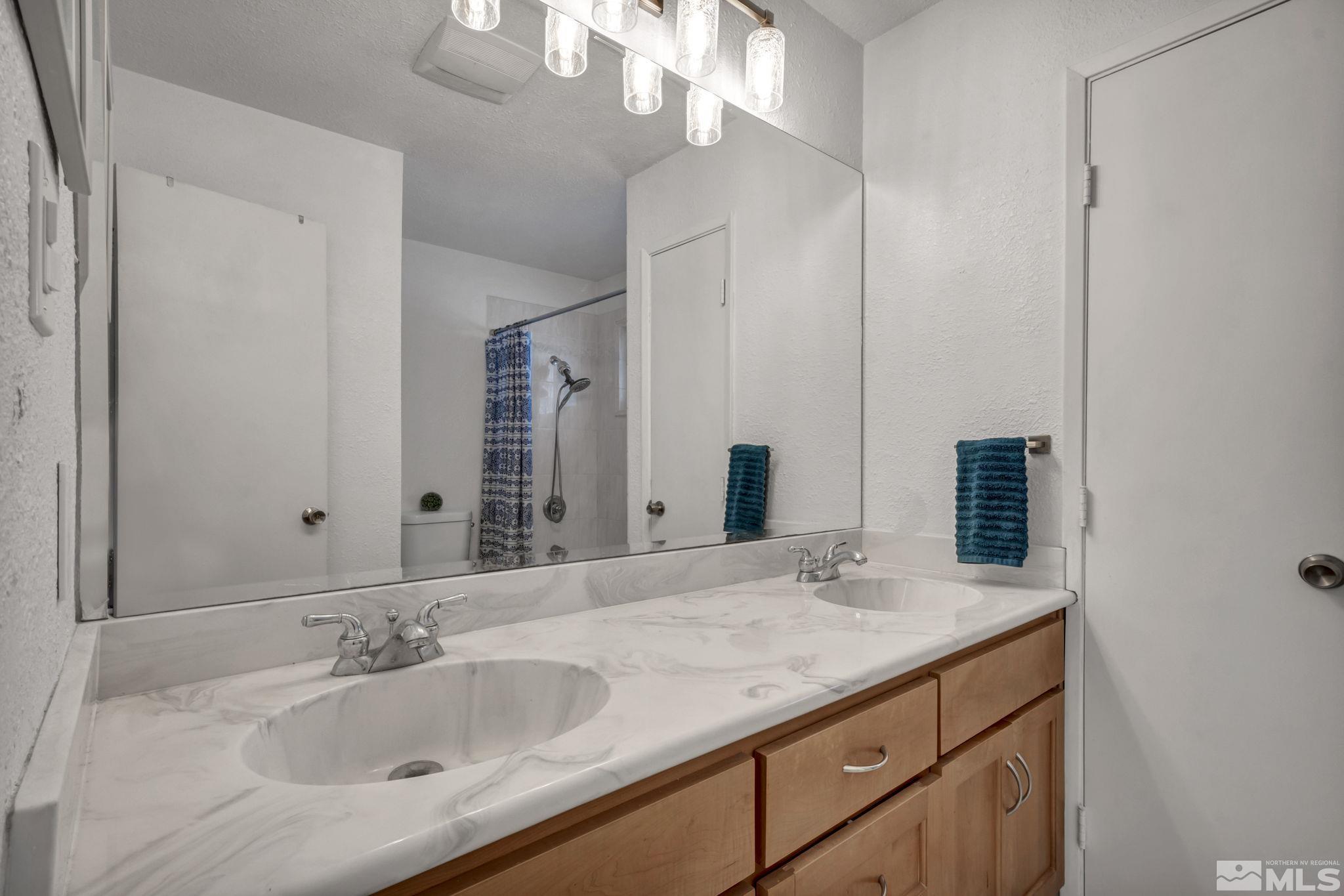 112 Smithridge Reno, NV 89502 - Photo 16 of 37 a bathroom with a granite countertop sink and a mirror