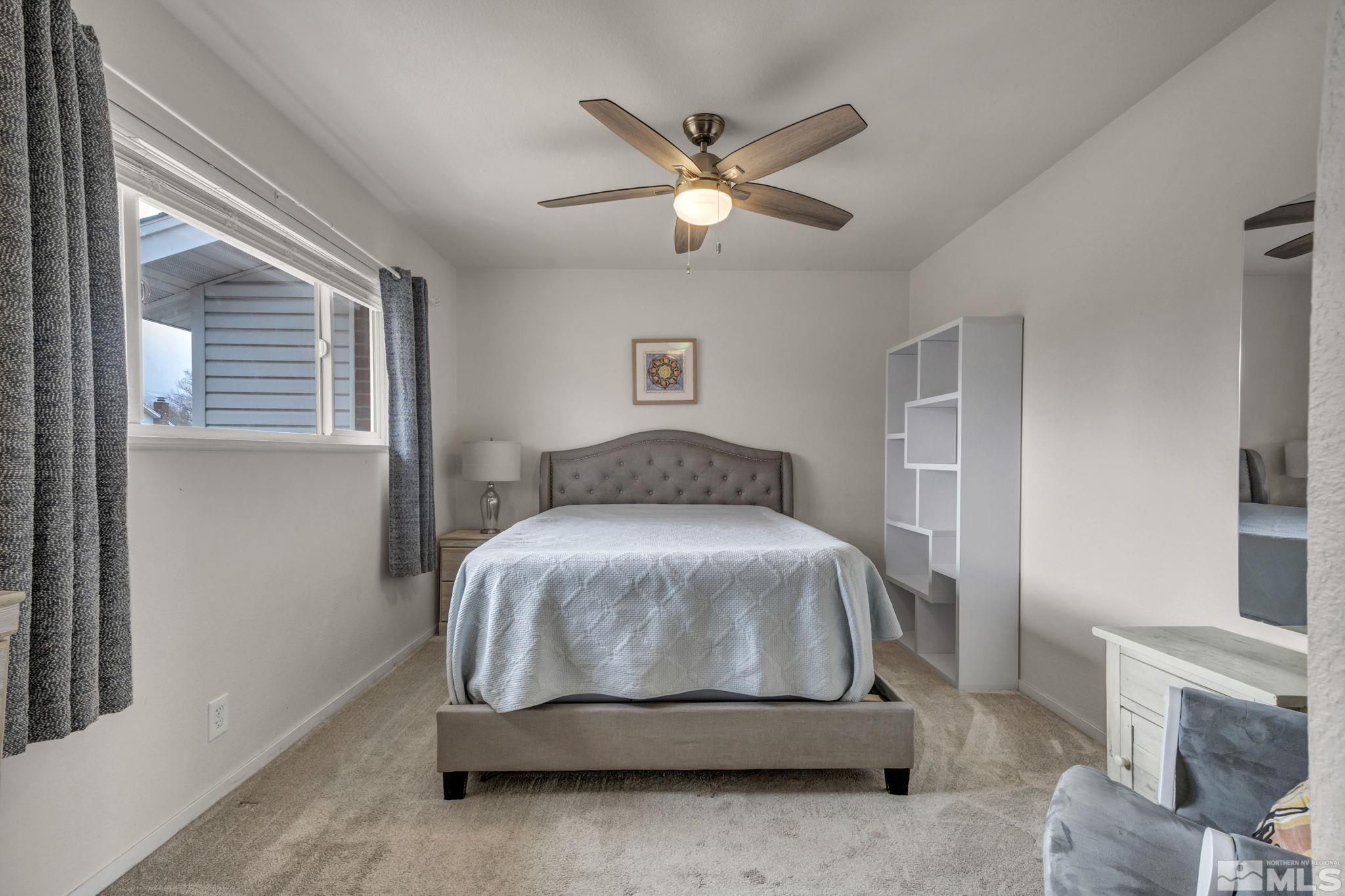 112 Smithridge Reno, NV 89502 - Photo 21 of 37 a bedroom with a bed and a ceiling fan