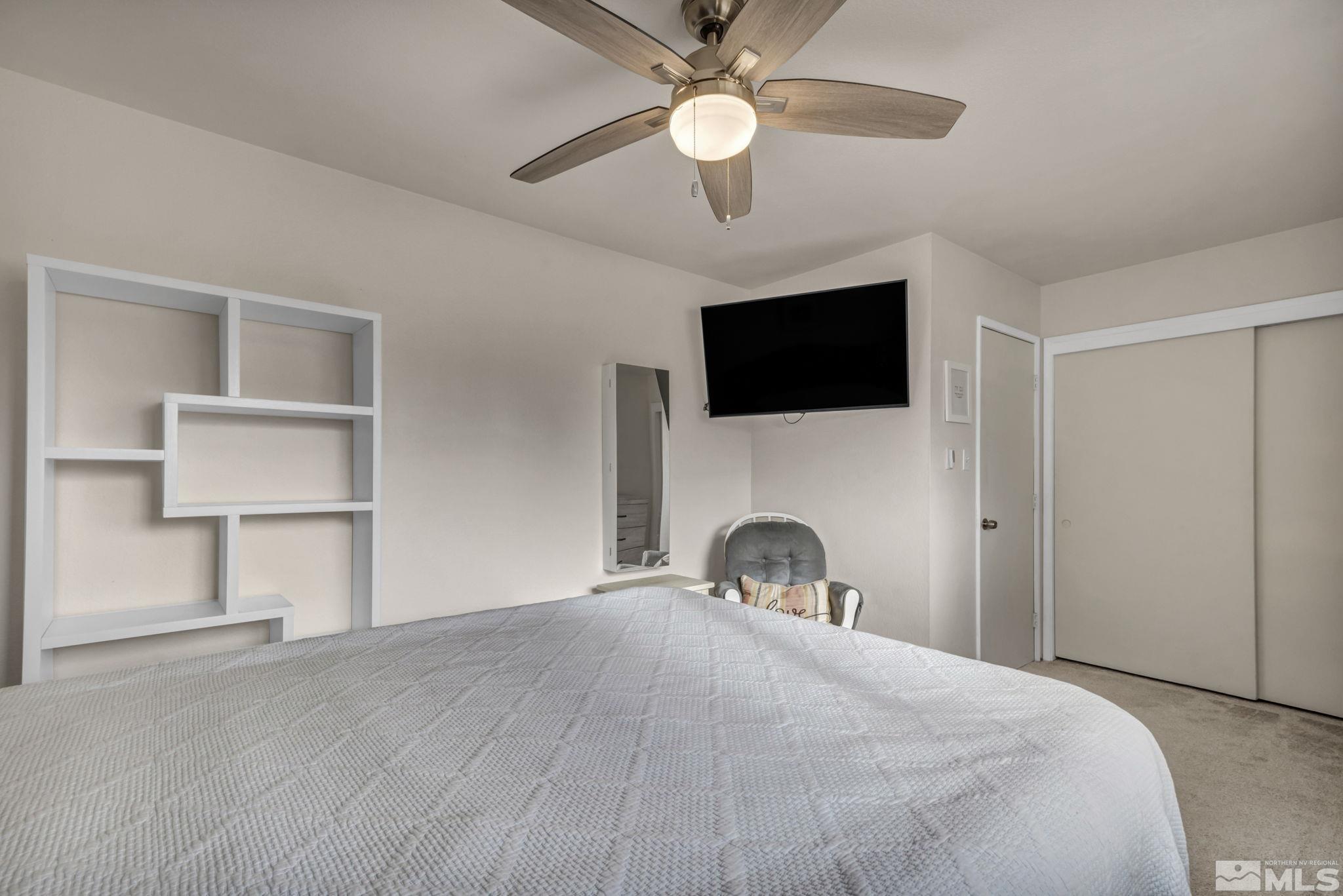 112 Smithridge Reno, NV 89502 - Photo 22 of 37 a bedroom with a bed and a flat screen tv
