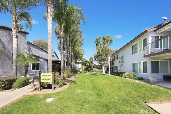 a view of a house with a yard patio and fire pit