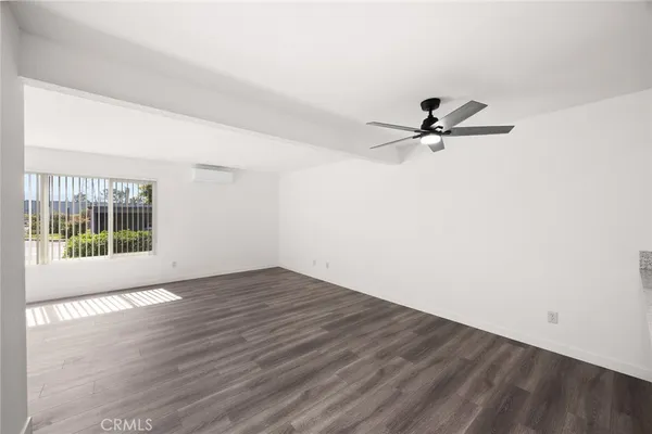 a view of a livingroom with a hardwood floor and a ceiling fan