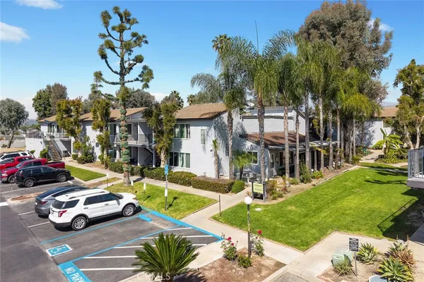 a front view of a residential apartment building with a yard