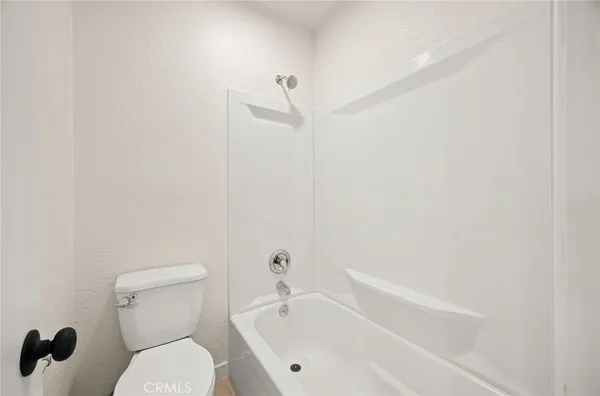 a bathroom with a toilet and a bathtub