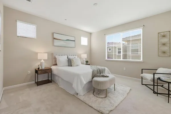 a spacious bedroom with a bed and a window