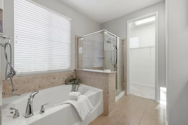 a bathroom with a tub and shower