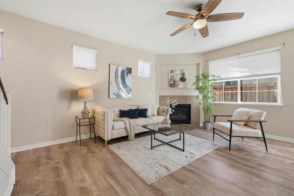 a living room with furniture and a fireplace