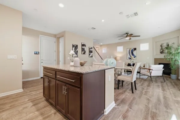 a kitchen with center island table and chairs