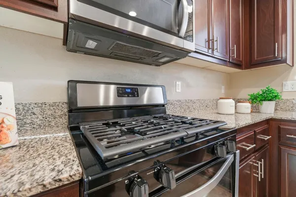 a stove top oven sitting inside of a kitchen