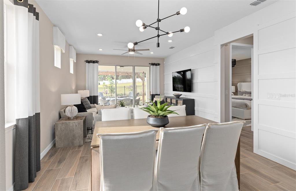 2370 Lily Bloom Road St. Cloud, FL 34771 - Photo 7 of 22 a view of a dining room with furniture window and wooden floor