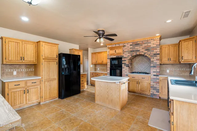 a kitchen with refrigerator cabinets and a sink