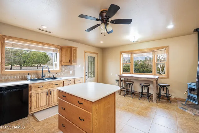 a kitchen with stainless steel appliances kitchen island granite countertop a sink and a stove
