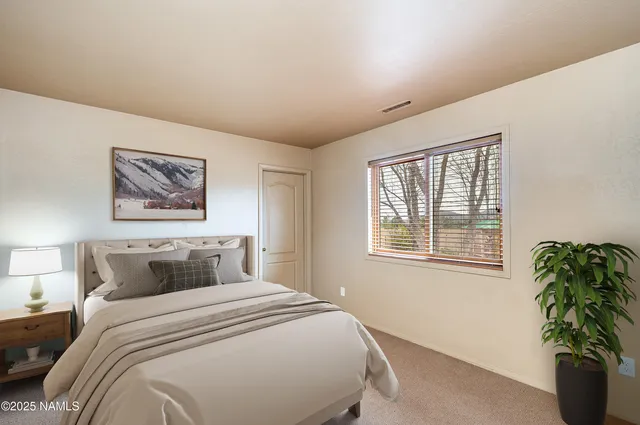 a bathroom with a granite countertop sink toilet and mirror
