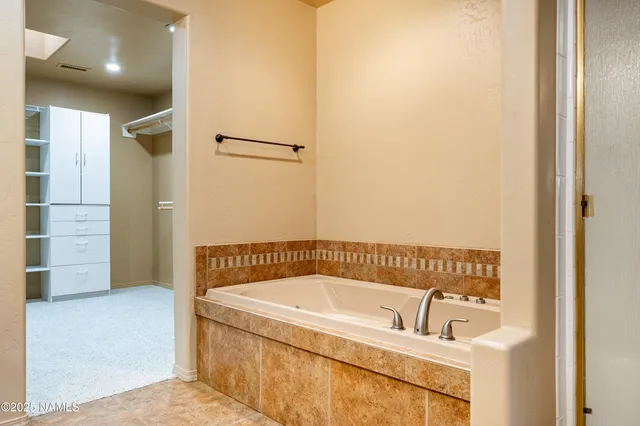 an empty room with a ceiling fan and window