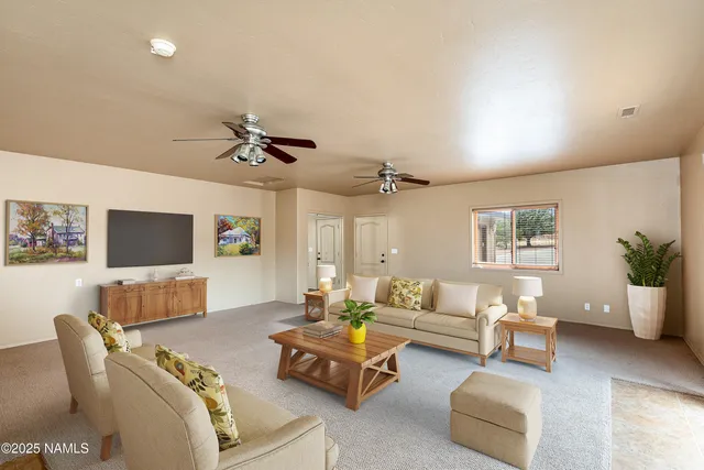 a view of a livingroom with furniture and a window