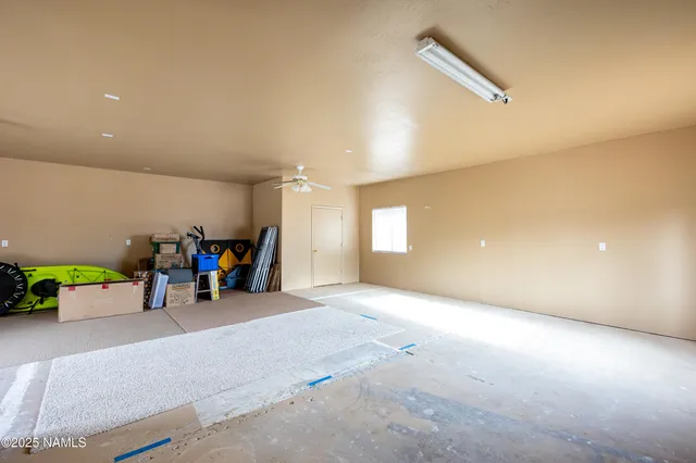 a view of backyard with wooden fence