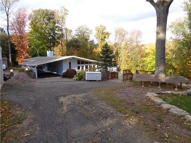 a view of a house with a yard and sitting area
