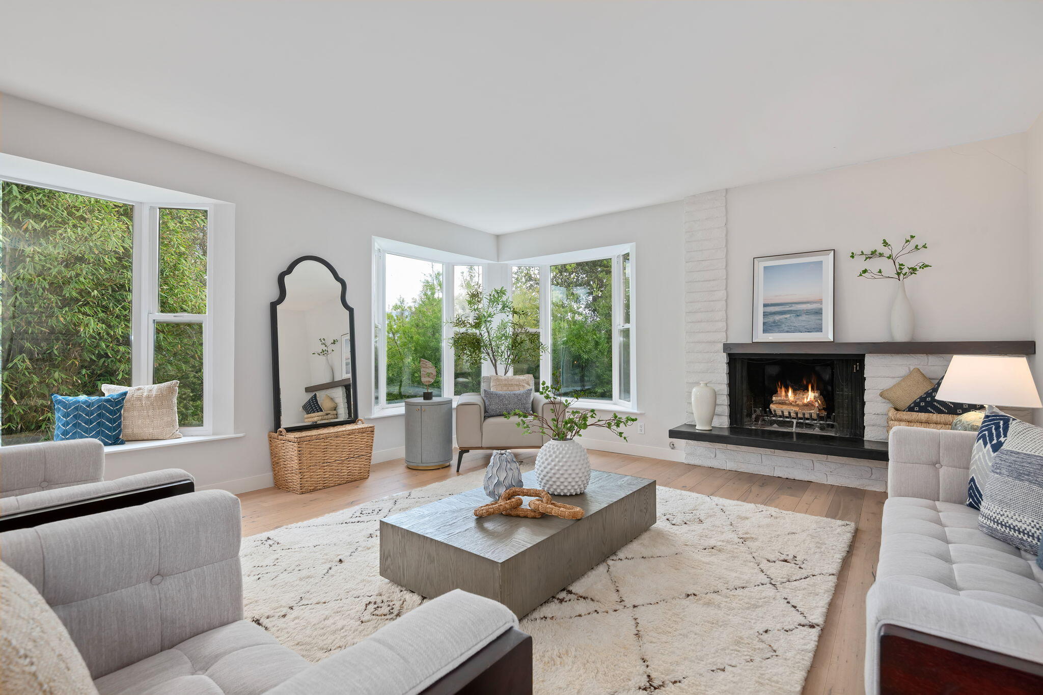a living room with furniture a large window and a fireplace