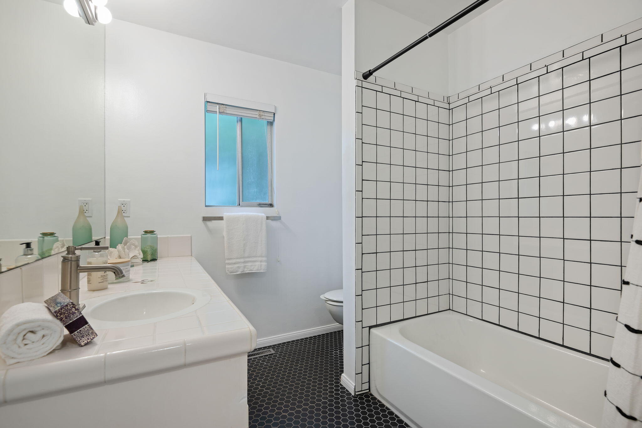 5 Fellowship Circle Santa Barbara, CA 93109 - Photo 15 of 32 a bathroom with a sink a mirror and a bathtub