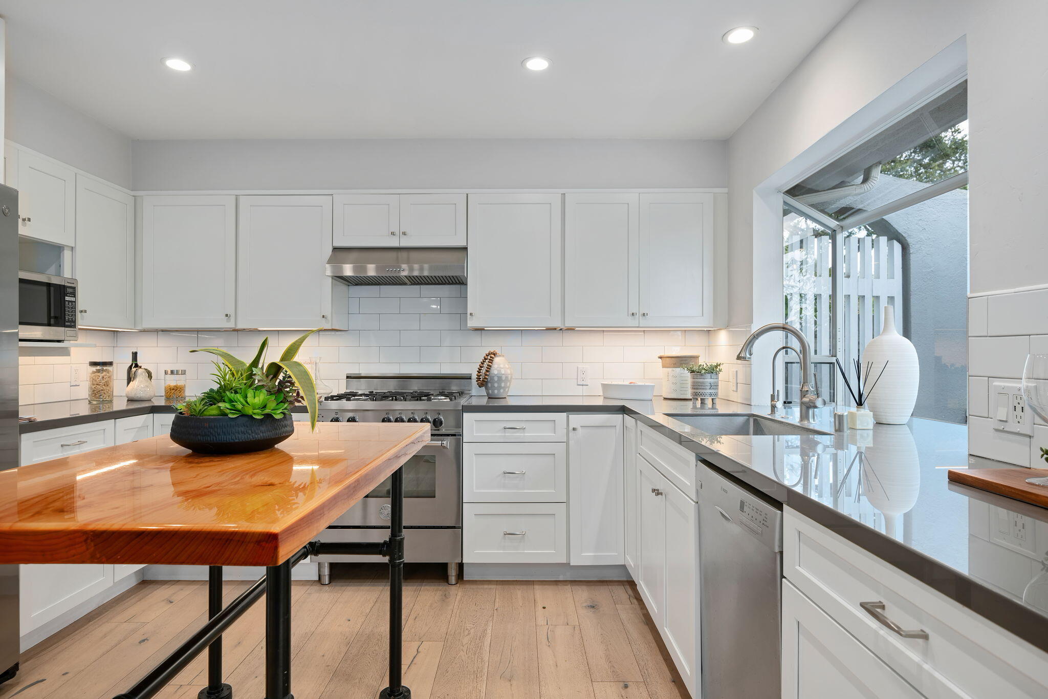 5 Fellowship Circle Santa Barbara, CA 93109 - Photo 8 of 32 a kitchen with a table chairs stove and cabinets