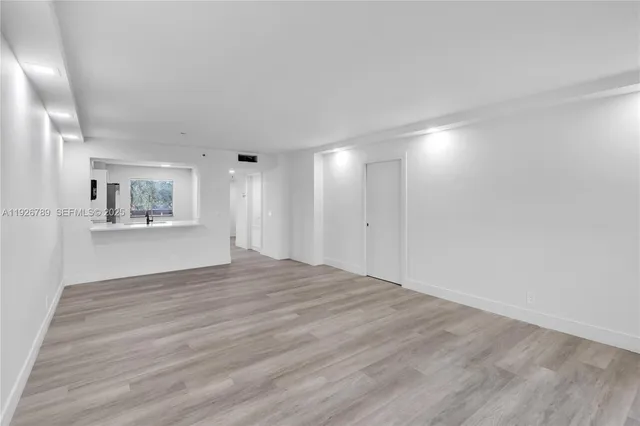 a view of an empty room with a window