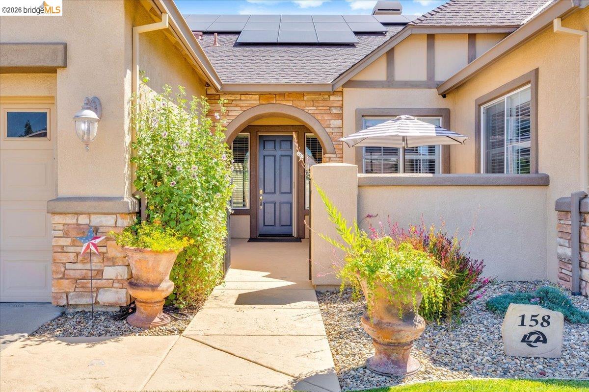158 Rock Ridge Lane Copperopolis, CA 95228 - Photo 6 of 72 Stucco exterior with stone accents and an arched entryway