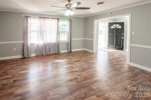 wooden floor in an empty room with a window