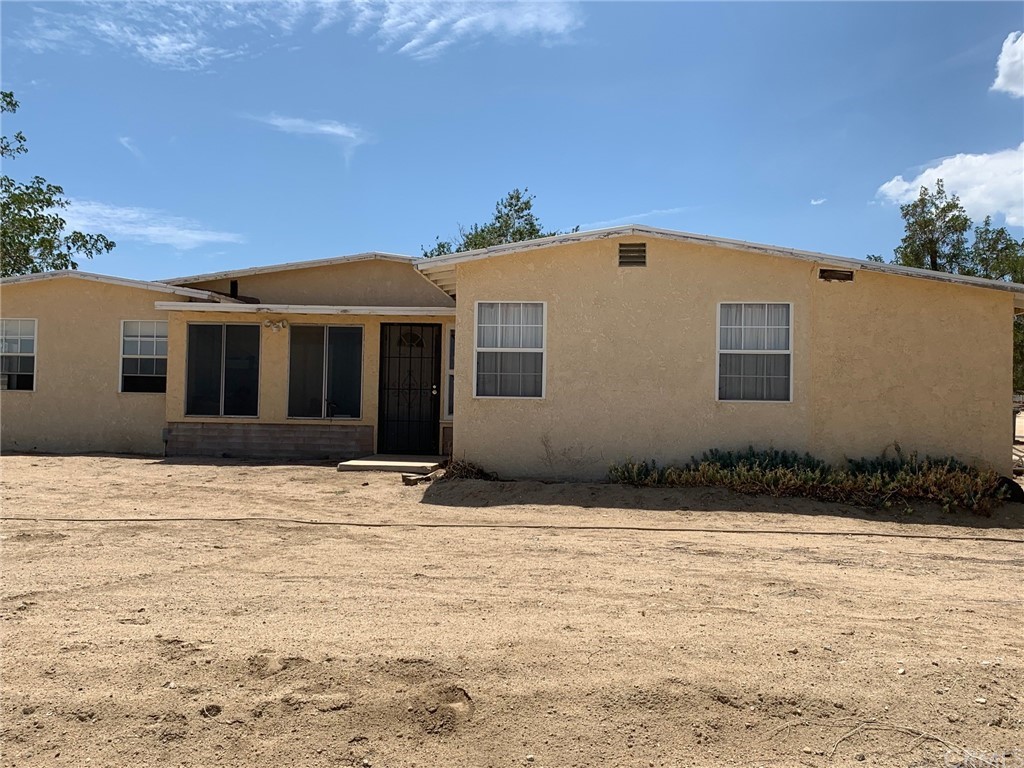 4175 Smoke Tree Road Phelan, CA 92371 - Photo 1 of 1 a front view of a house with a yard