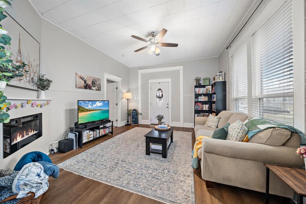 1916 Mitchell Avenue Waco, TX 76708 - Photo 17 of 32 a living room with furniture a fireplace and a flat screen tv