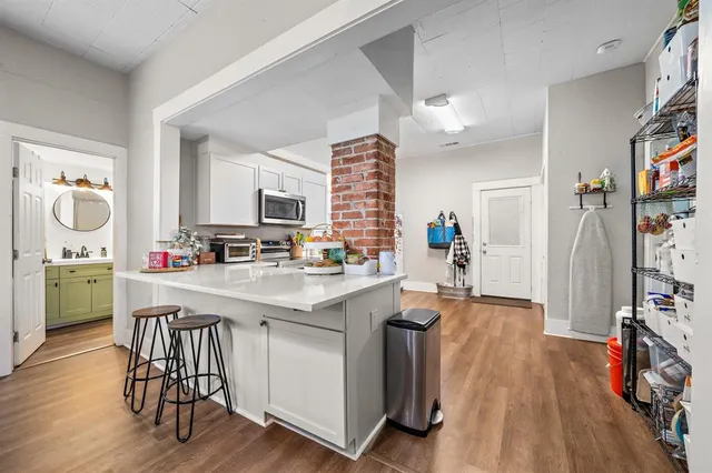 a kitchen with a sink appliances and cabinets