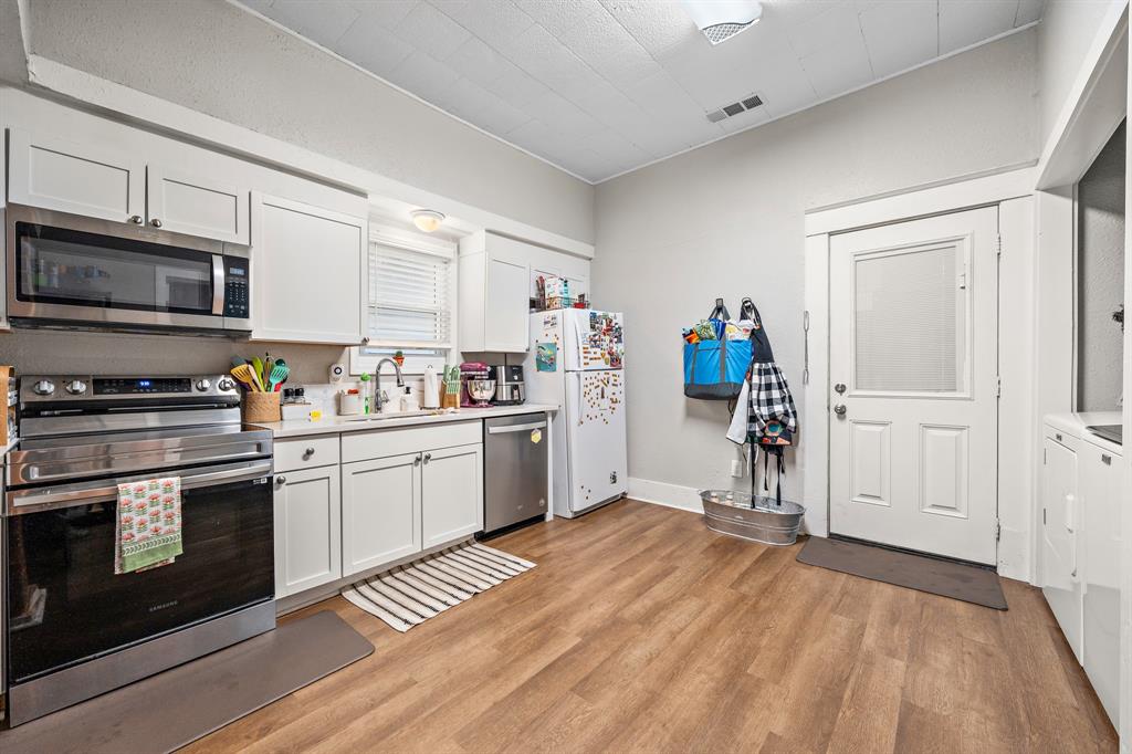 1916 Mitchell Avenue Waco, TX 76708 - Photo 22 of 32 a kitchen with granite countertop a stove and a sink
