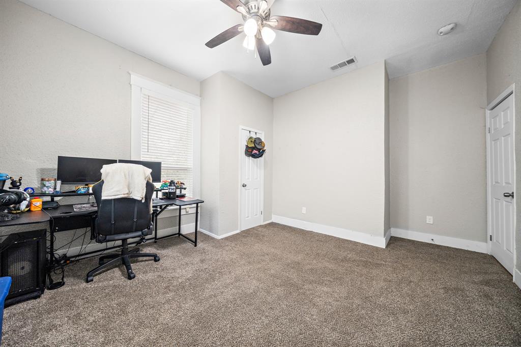 1916 Mitchell Avenue Waco, TX 76708 - Photo 25 of 32 a view of a workspace with furniture and a window