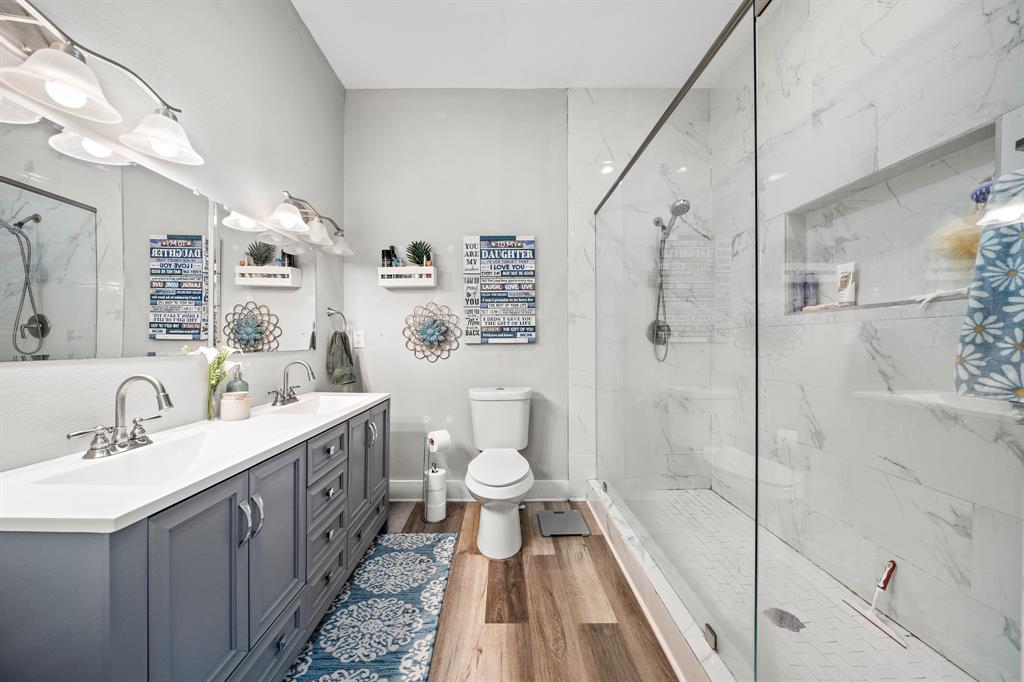 1916 Mitchell Avenue Waco, TX 76708 - Photo 28 of 32 a bathroom with a double vanity sink toilet and shower
