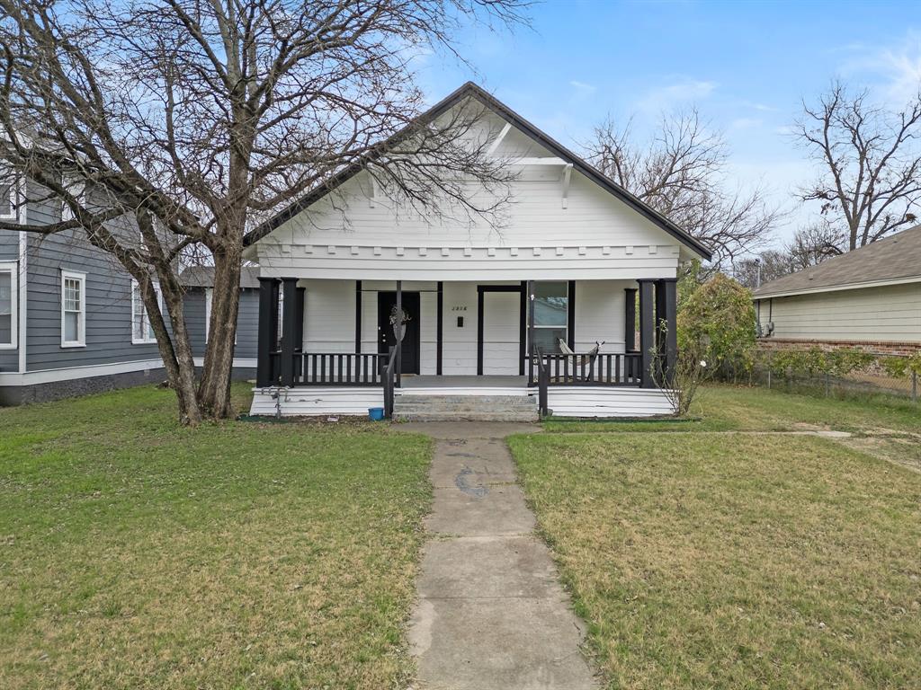 1916 Mitchell Avenue Waco, TX 76708 - Photo 3 of 32 a front view of a house with a garden and trees