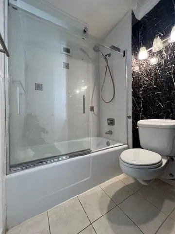 a bathroom with a toilet sink and shower