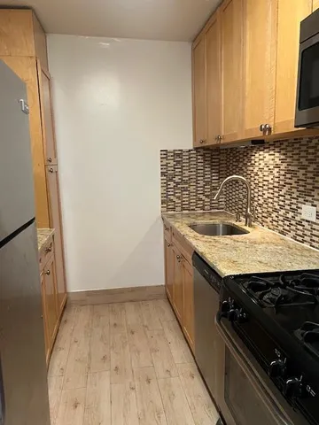 a kitchen with a sink stove and microwave