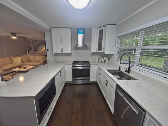 a kitchen with a sink stove and cabinets