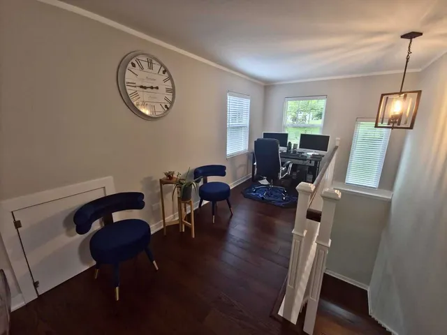 a view of a workspace with furniture and a window
