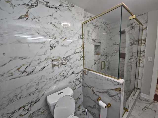 a bathroom with a shower and a sink