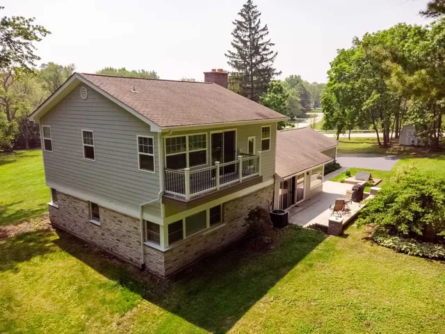 a view of a house with pool and chairs