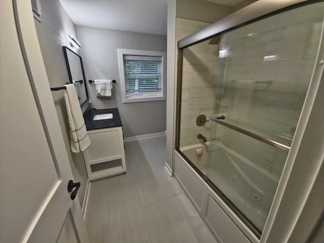 a view of a house with a big yard and large trees