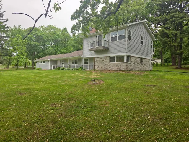 a view of a house with a yard and garage